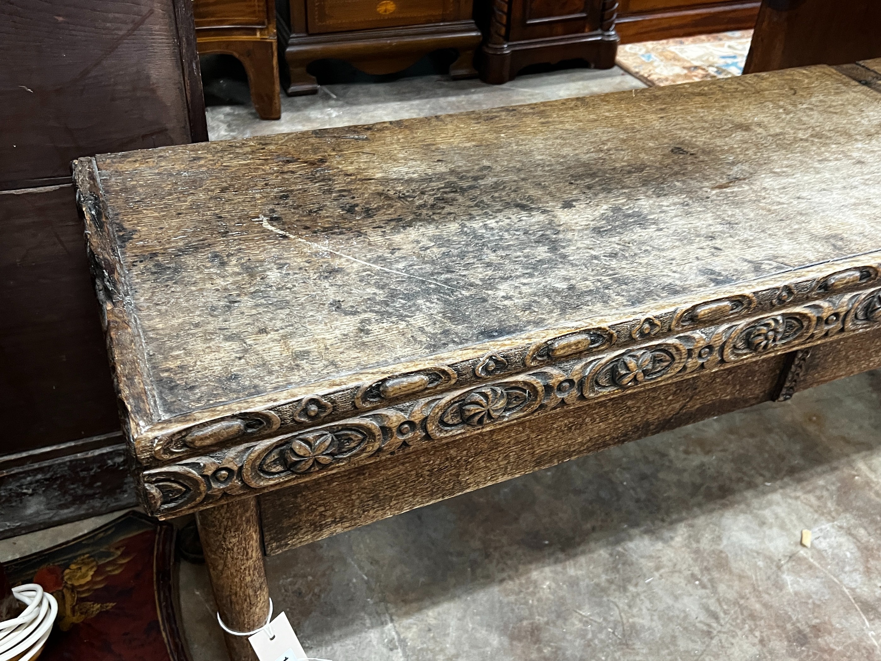 An 18th century and later carved oak hall bench with twin hinged box seat, width 183cm, depth 40cm, height 55cm